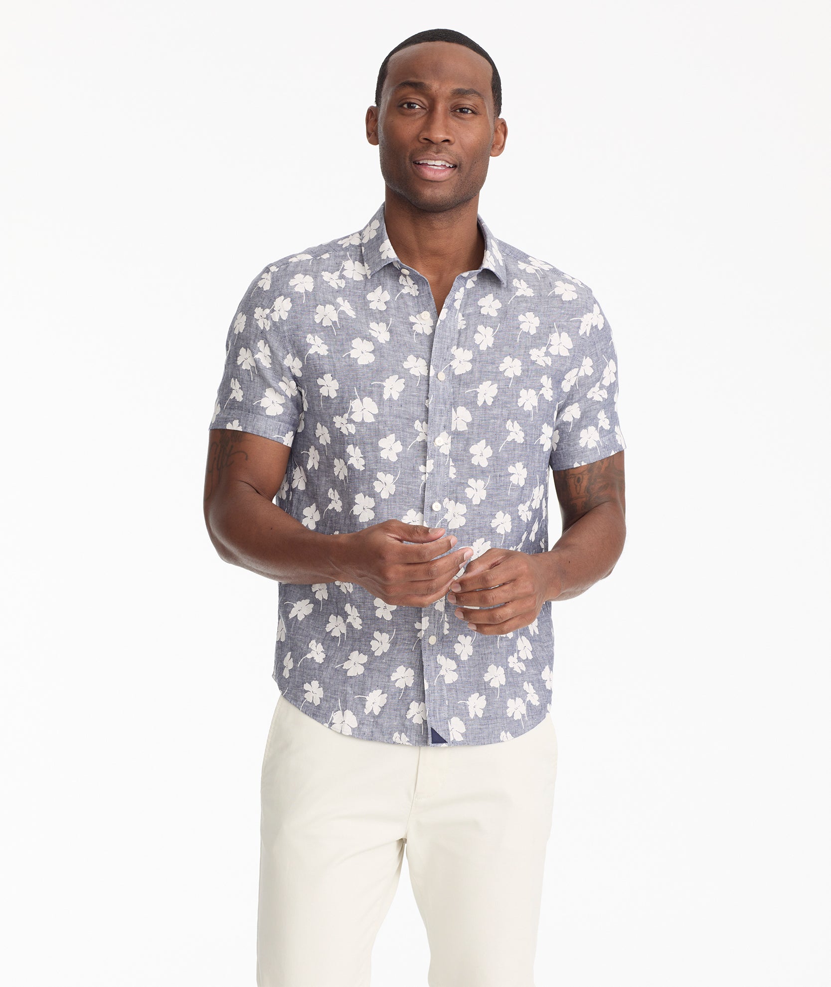 Model is wearing UNTUCKit bonner short sleeve shirt in Chambray Floral.