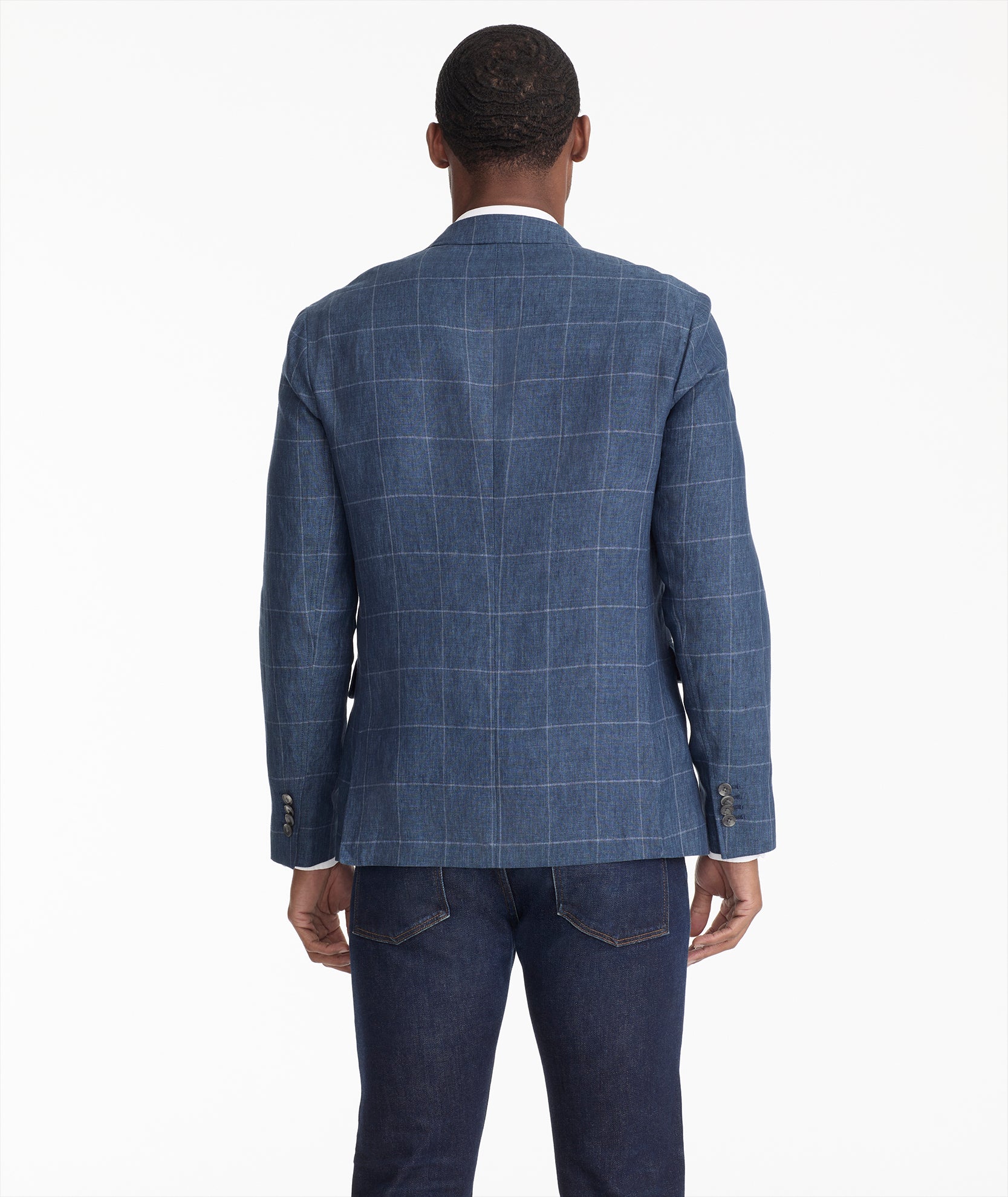 Model is wearing UNTUCKIt Hampton sport coat in navy.