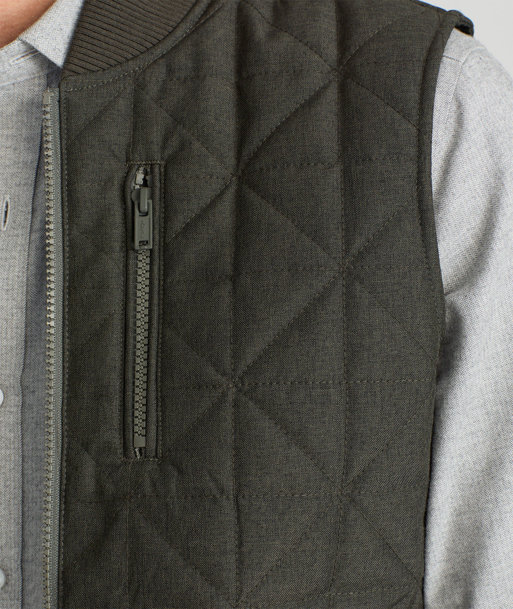 Model is wearing UNTUCKit Harper vest in dark gray/green.