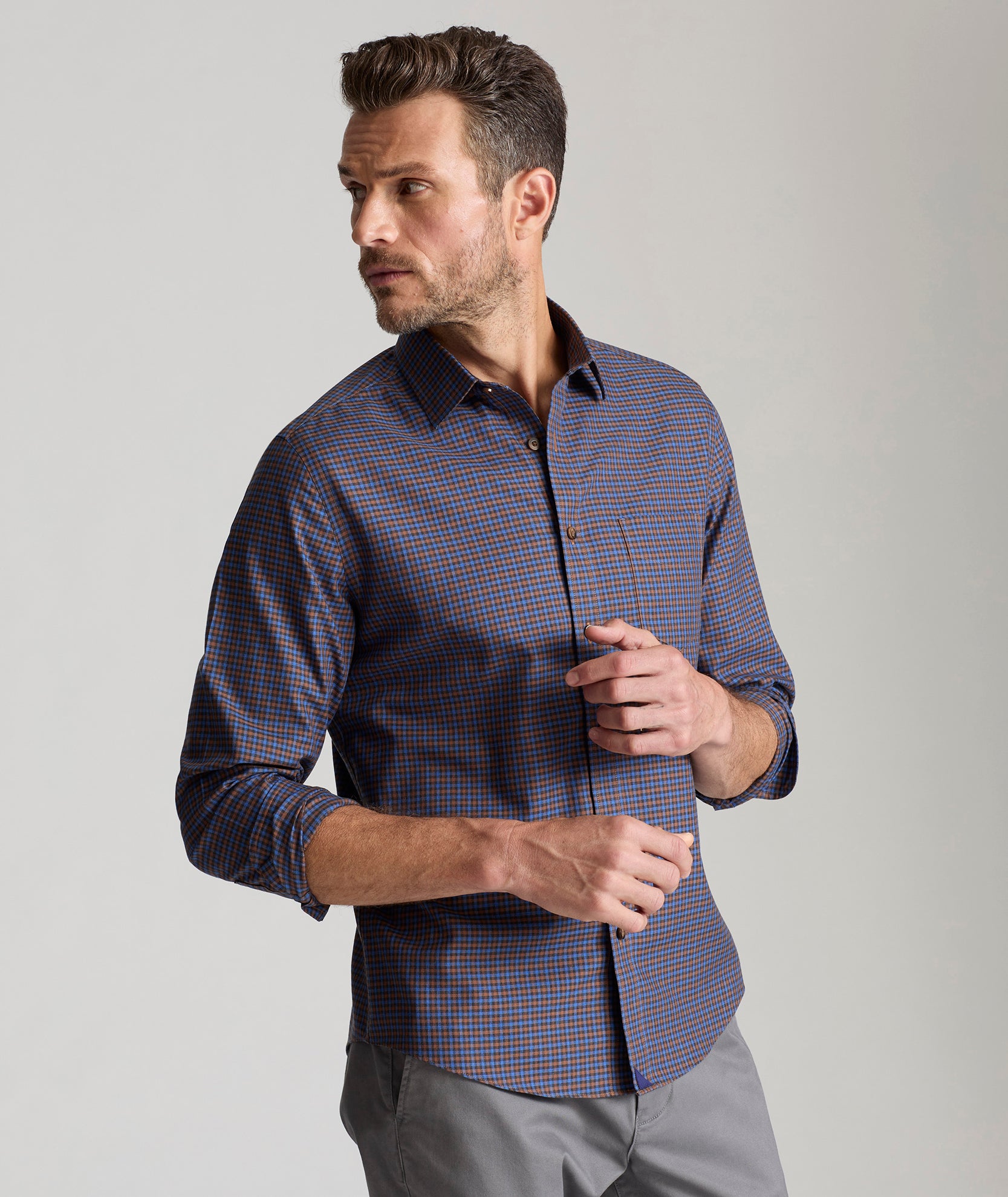 Model is wearing UNTUCKit Knight wrinkle-free long sleeve in brown and blue grey check.