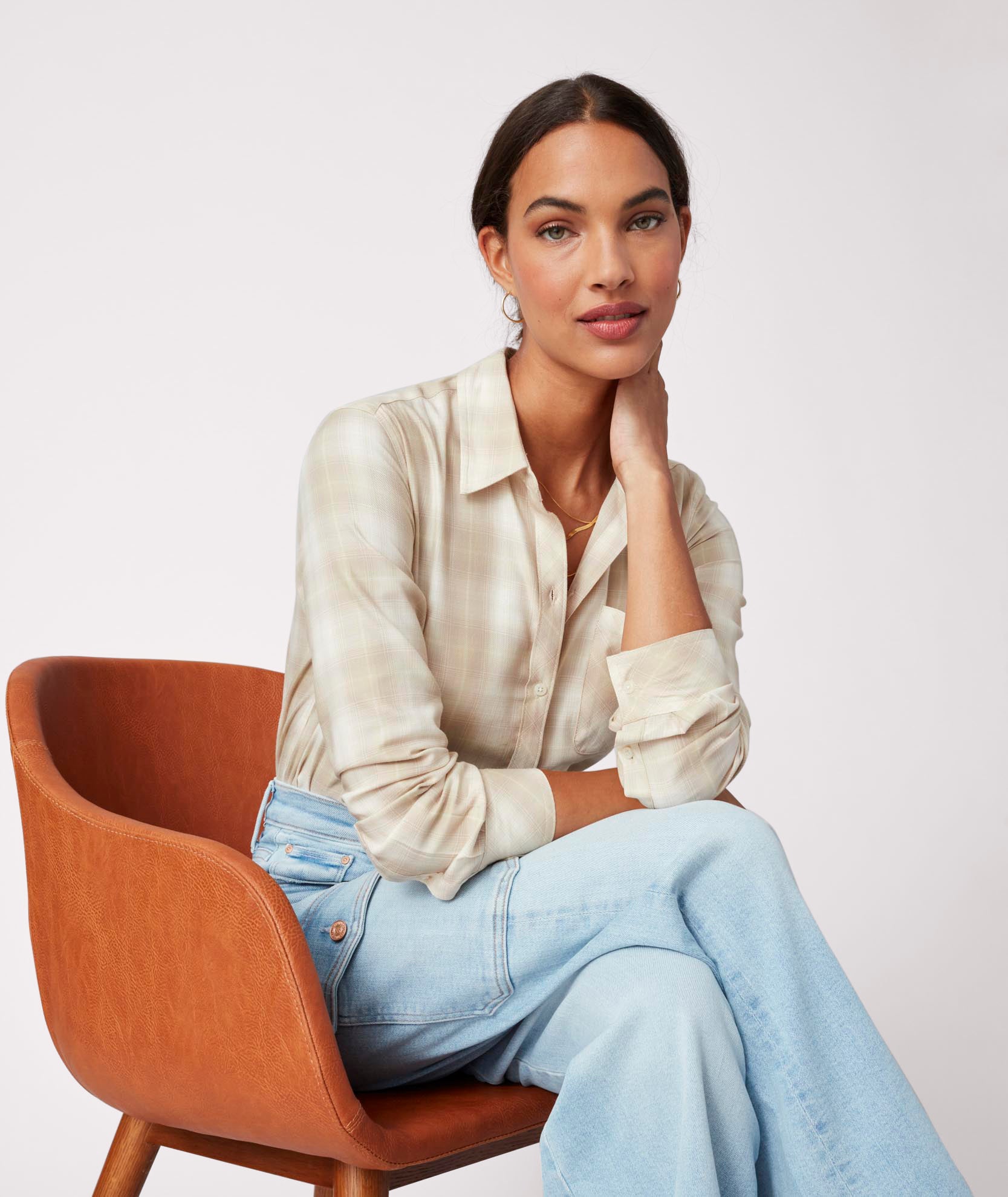 Model is wearing UNTUCKit Layla shirt in tan.