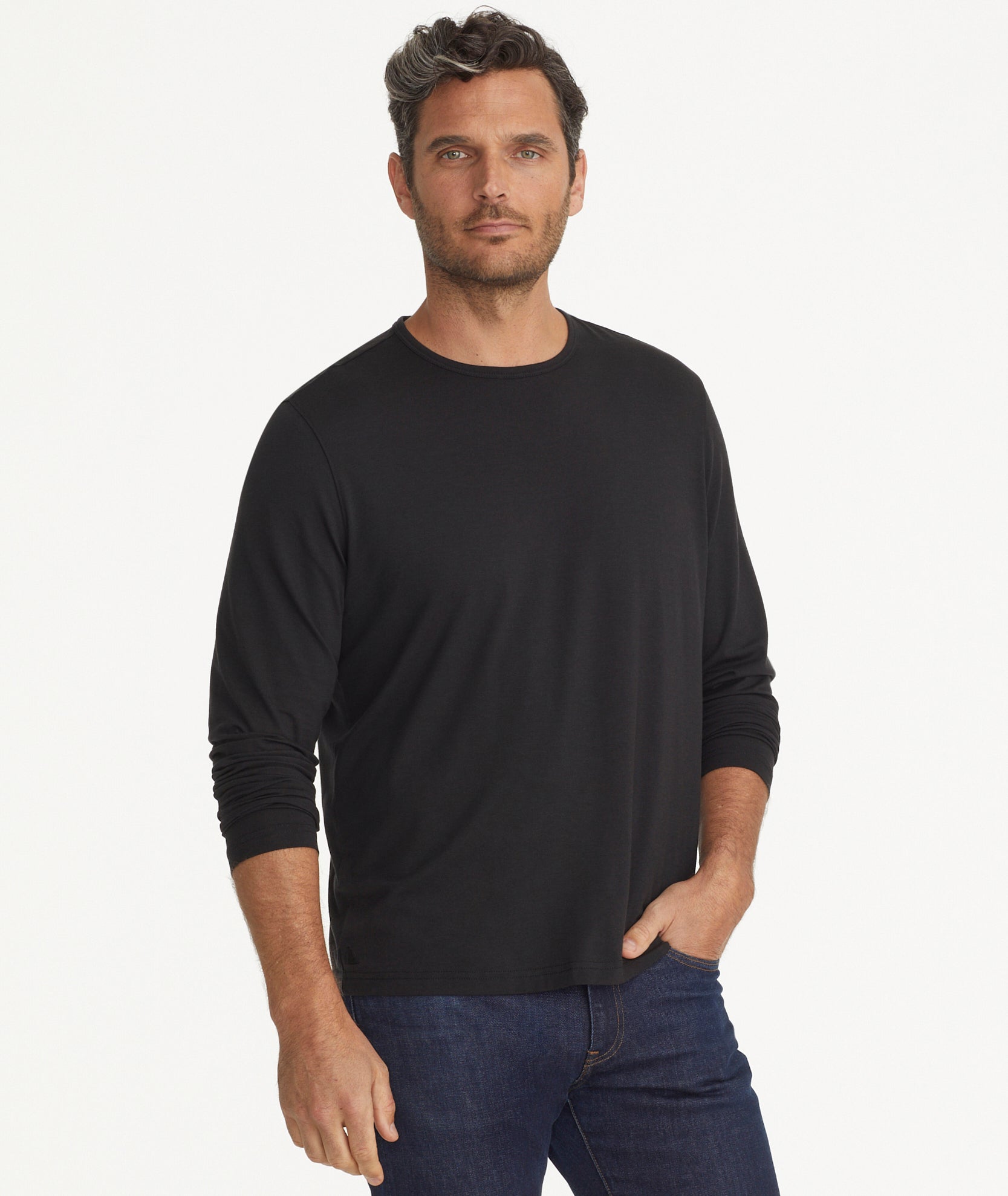 Model is wearing UNTUCKIt Merille long sleeve Tencel Tee in black.