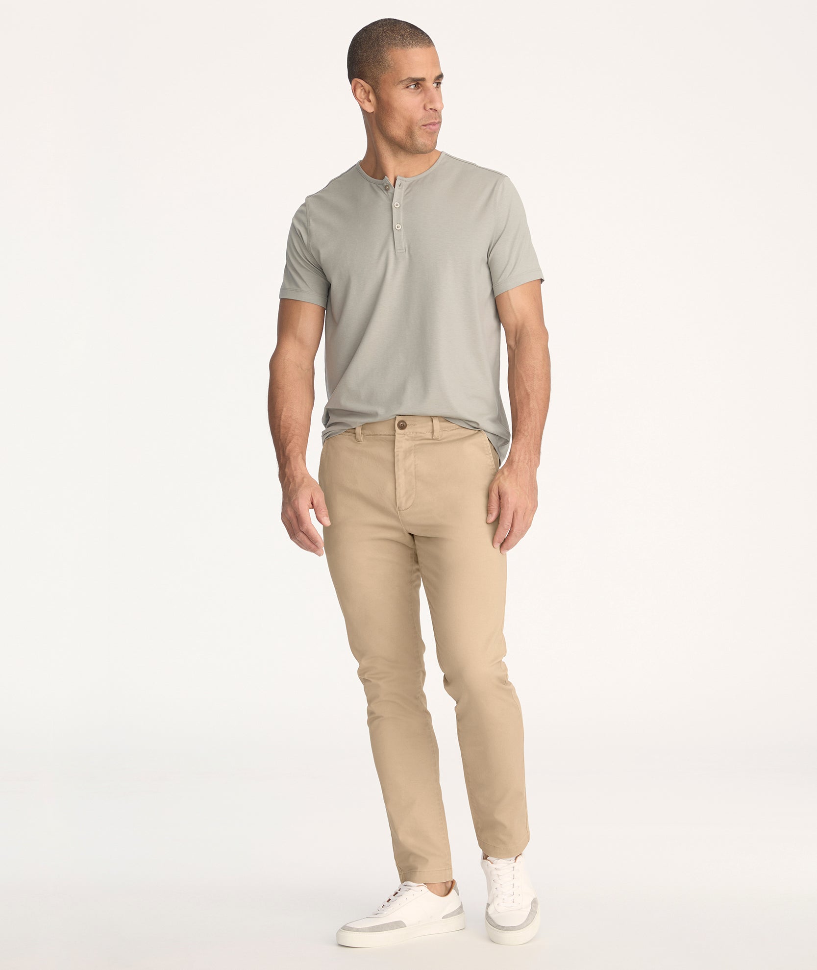 Model is wearing UNTUCKit Classic Chino Pants in Khaki - full body