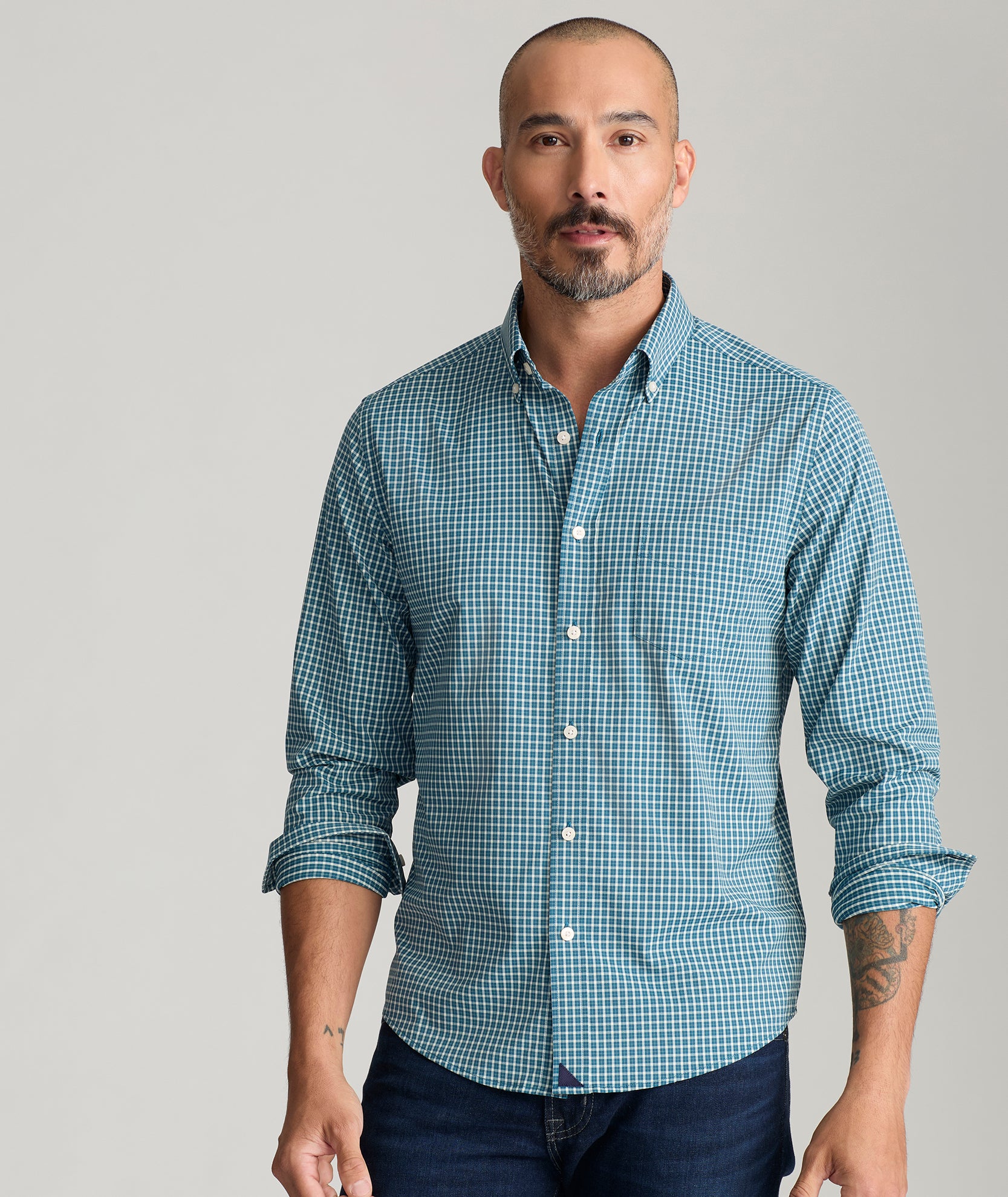 Model is wearing UNTUCKit Tully shirt in green.