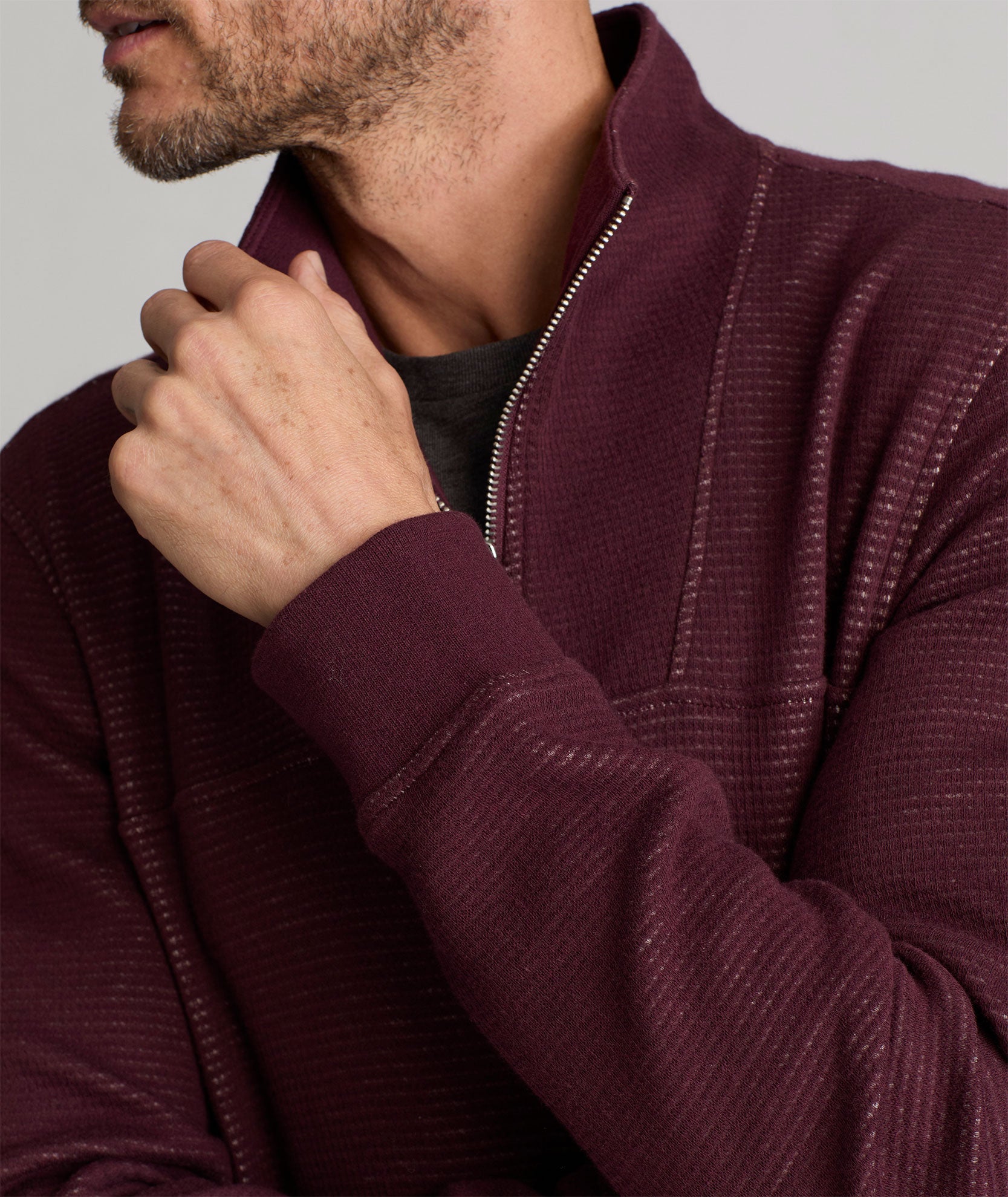 Model is wearing UNTUCKit Verzaro Textured Quarter-Zip in Winetasting.