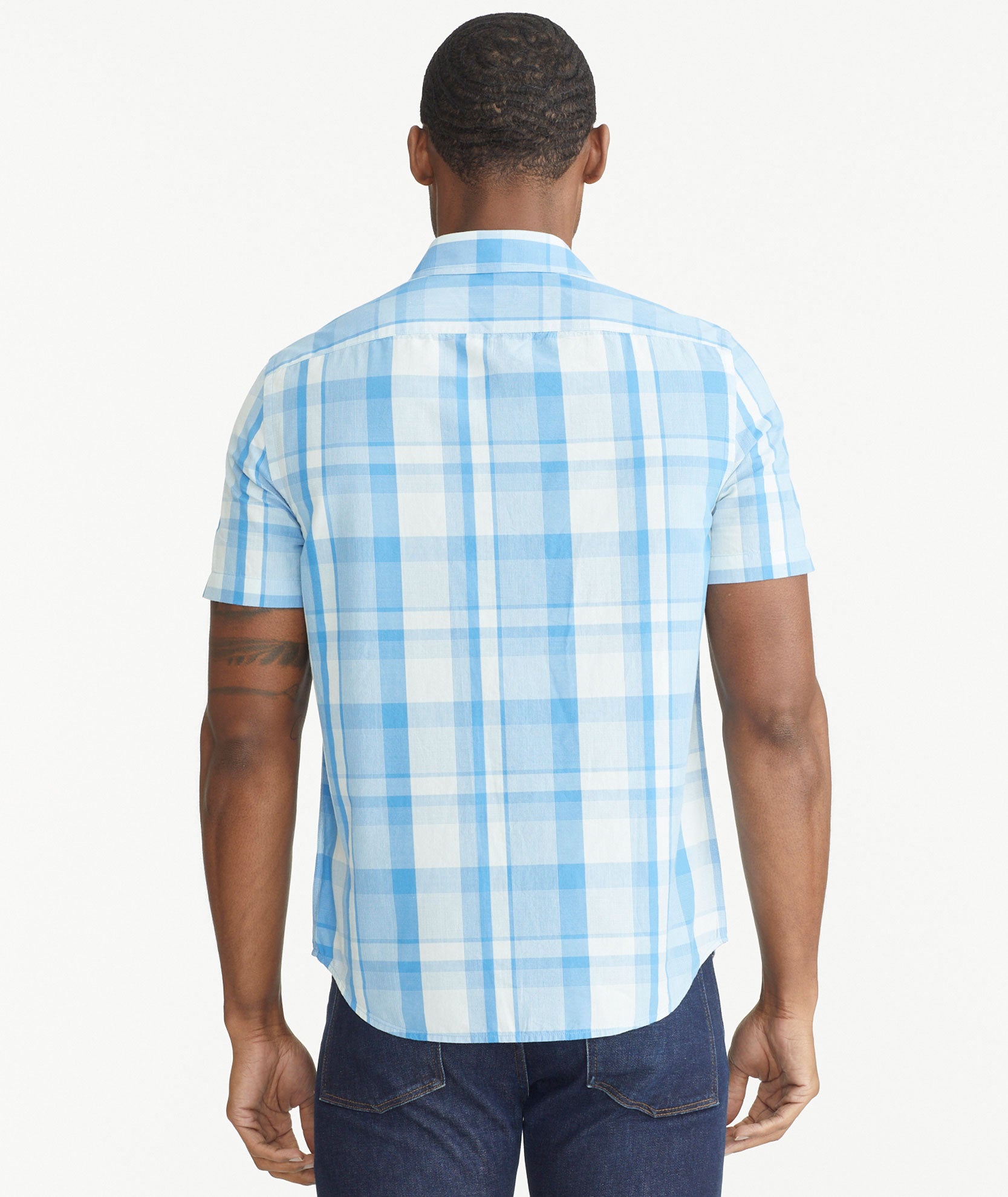 Model is wearing UNTUCKit Blue Cotton Short-Sleeve Plaid Shirt.