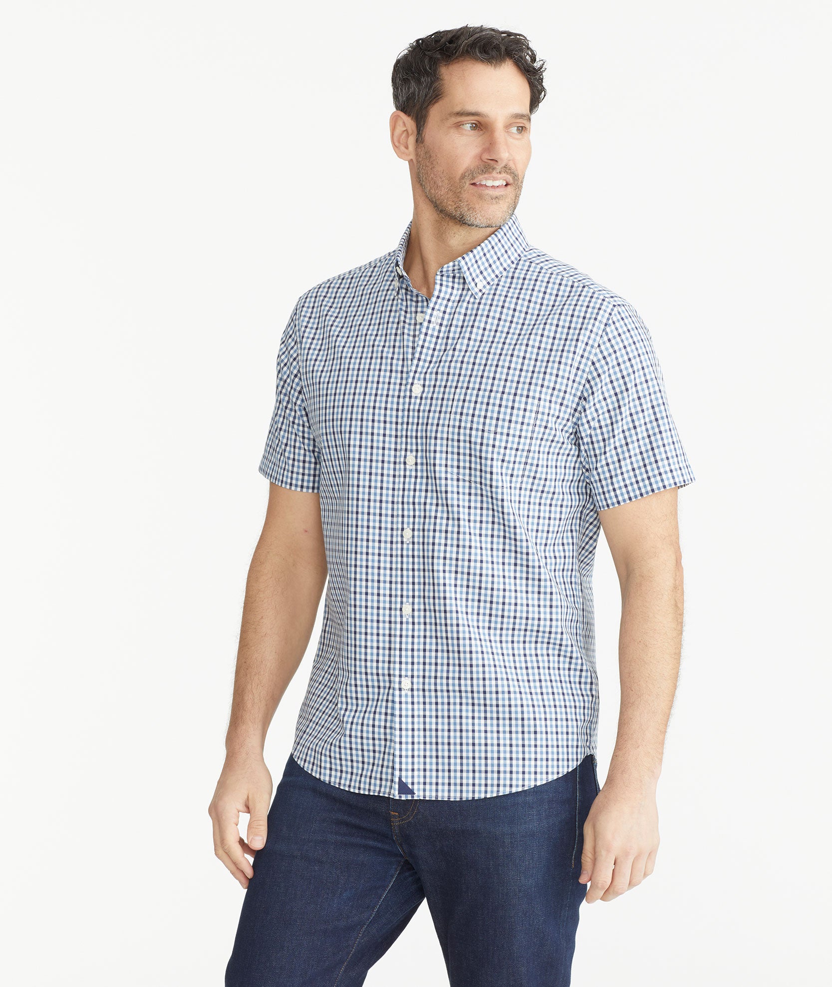 Model is wearing UNTUCKit Teal & Navy Check Wrinkle-Free Short-Sleeve Melvald Shirt.